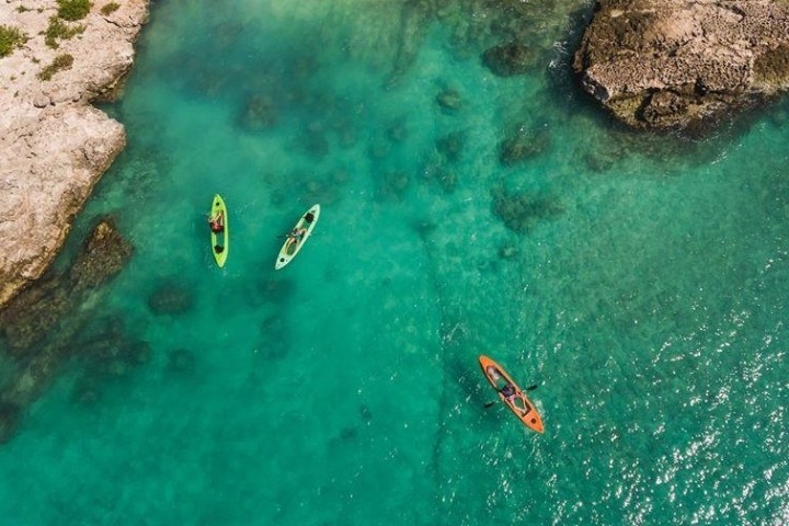 Three people on paddle boards.