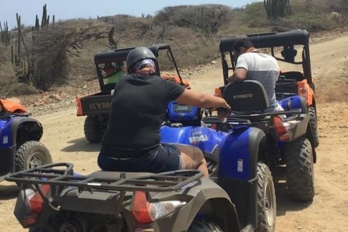 a person riding a motorcycle down a dirt road